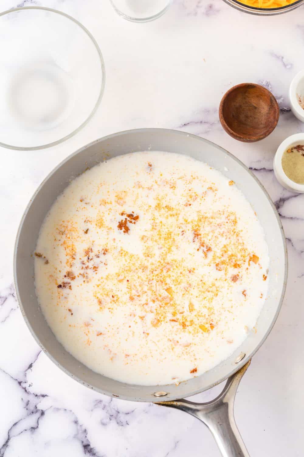 a pot of ingredients for ham and potato casserole