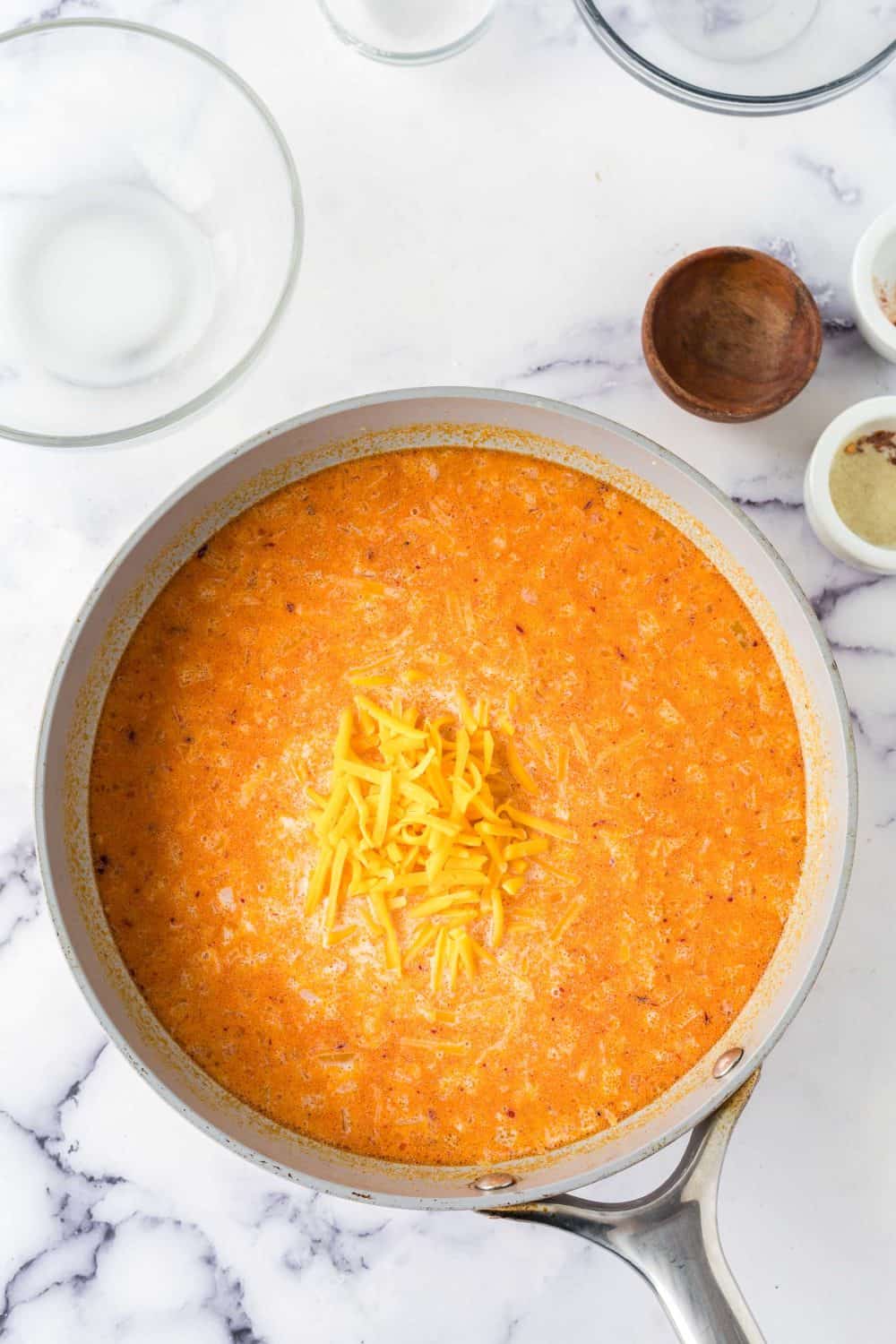 a pot of ingredients for ham and potato casserole