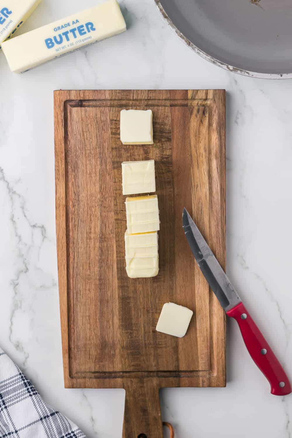 Cutting butter into cubes to brown butter.