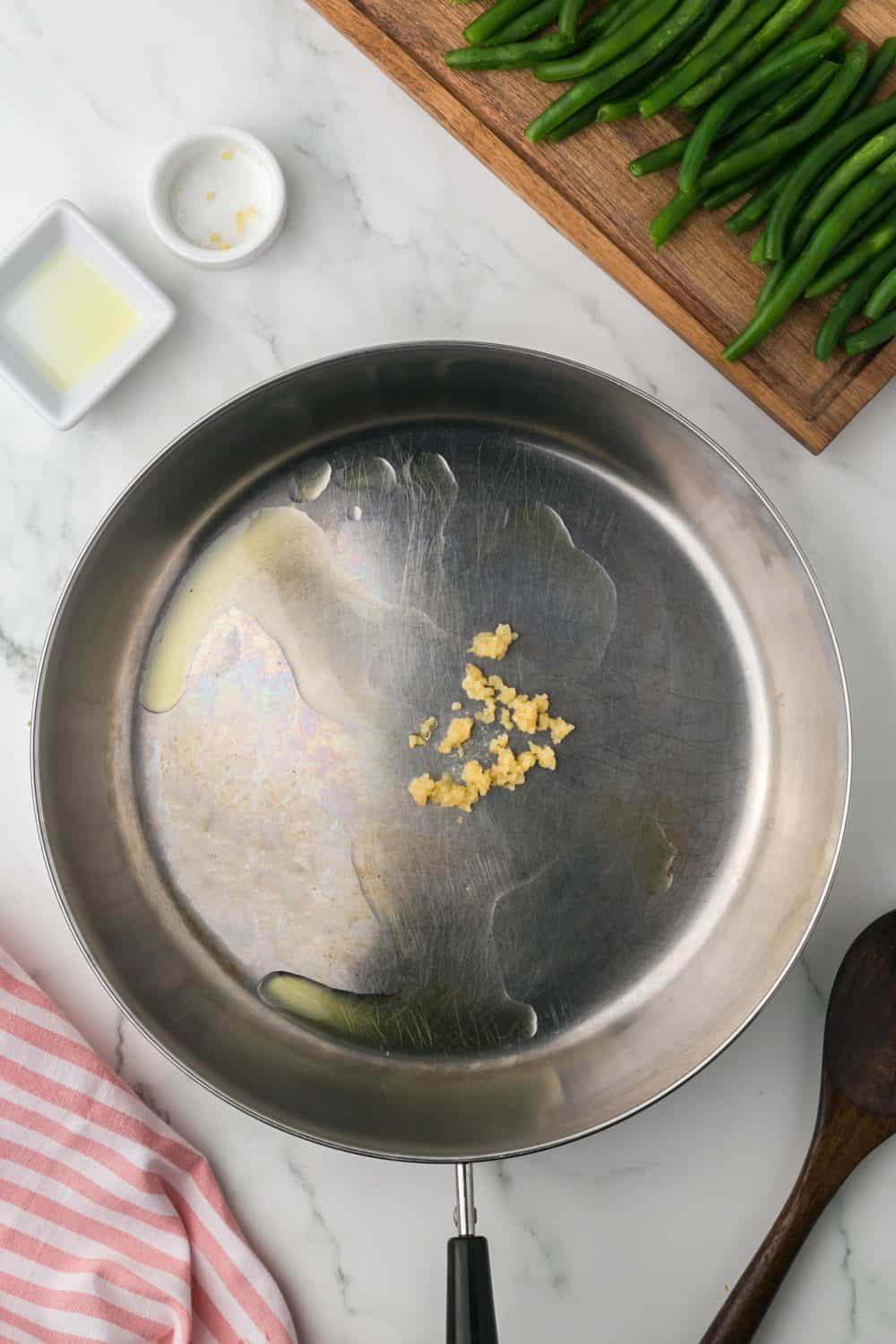 a pan with oil and garlic