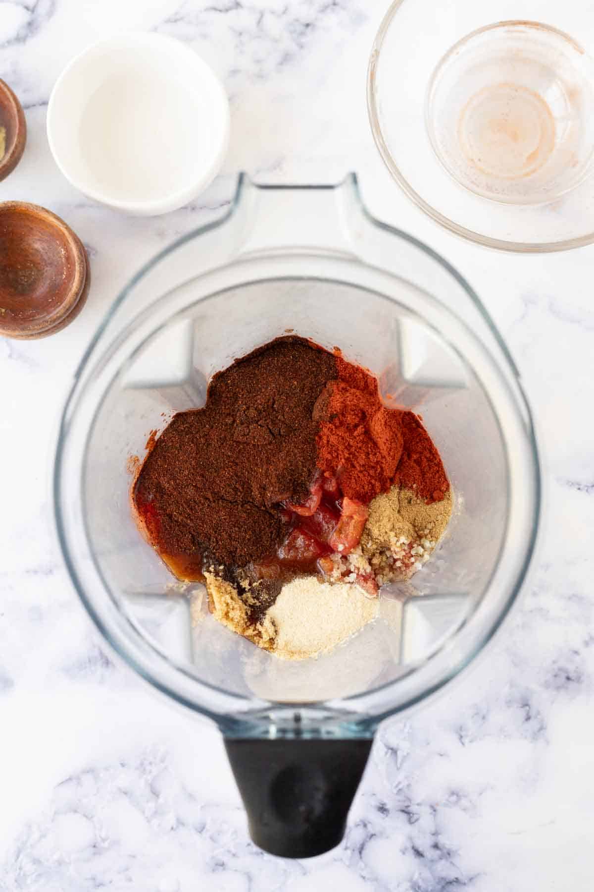 Ingredients for adobo sauce in a blender.