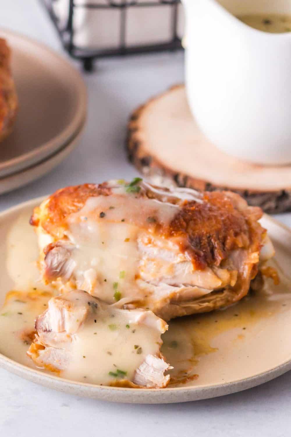Meat dripped in chicken gravy served on a plate.