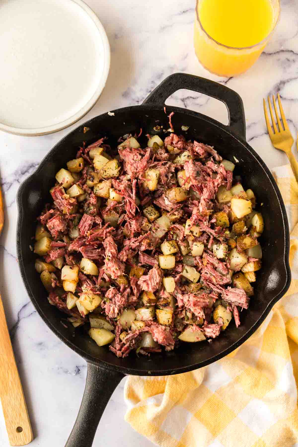 Completed corned beef hash in a skillet.