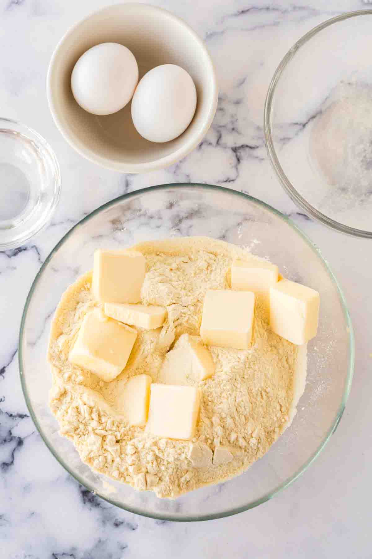 clear mixing bowl with dry ingredients for empanada dough.