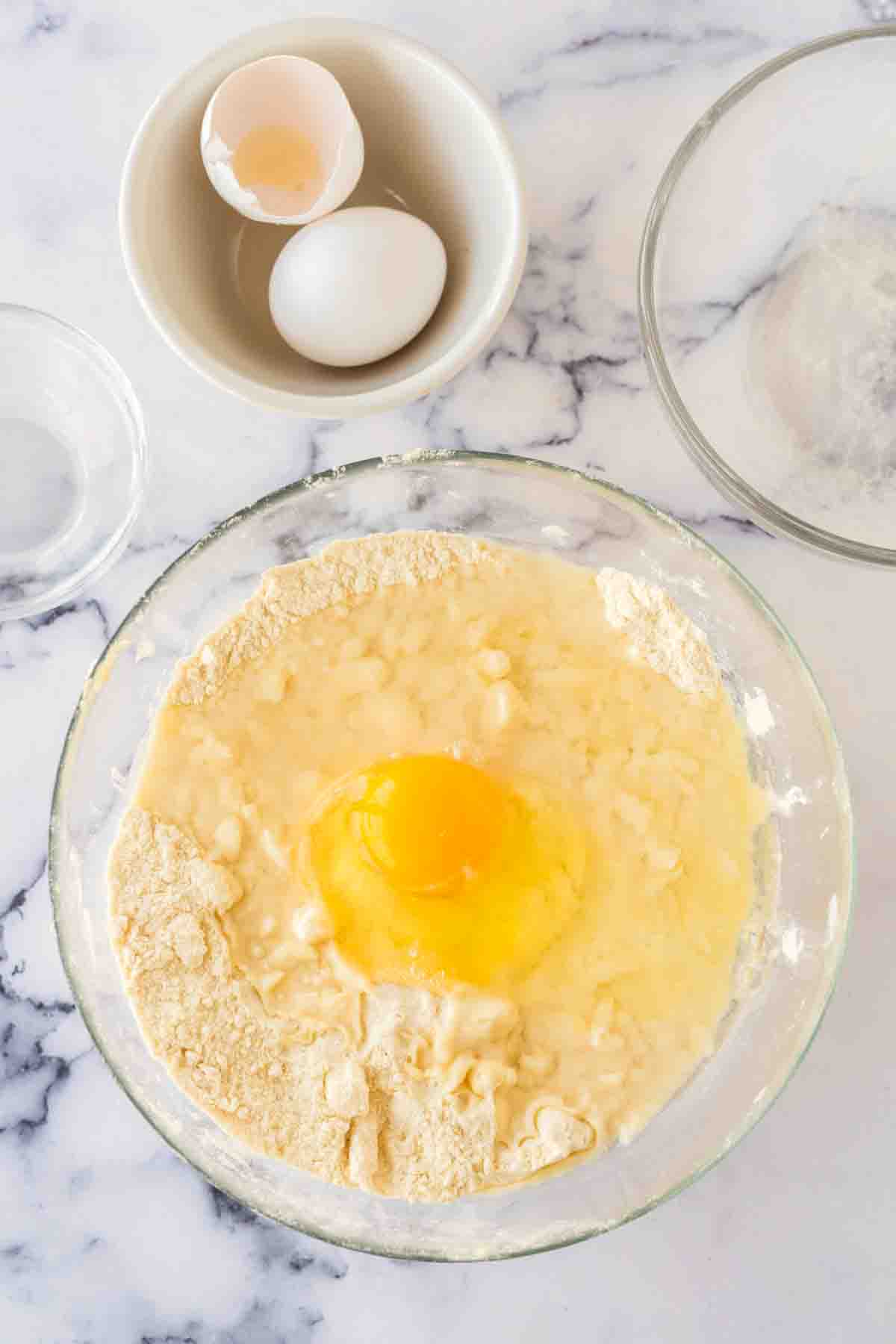 clear mixing bowl with empanada dough recipe.