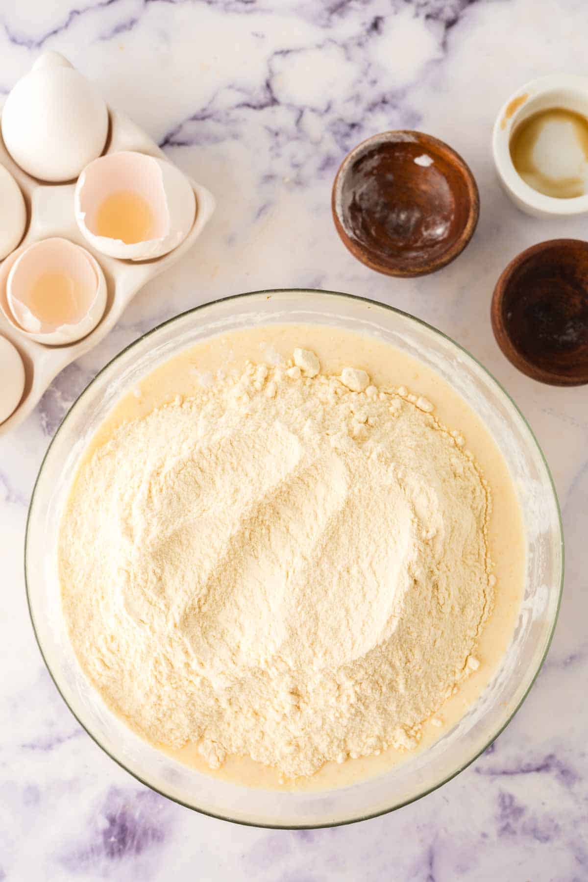 clear mixing bowl with ingredients to make buttermilk waffle butter in stages.