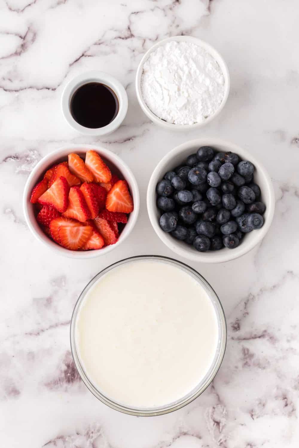 portion bowls each with raw ingredient to make berries and cream recipe.