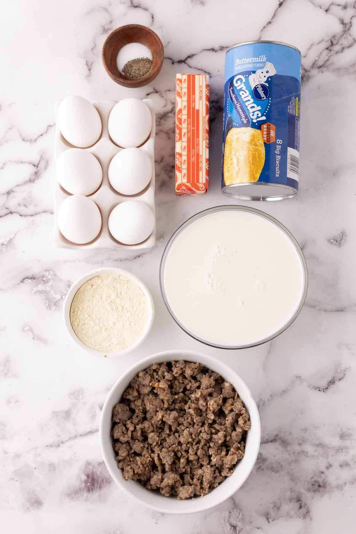 portion bowls each with raw ingredient to make biscuits and gravy.
