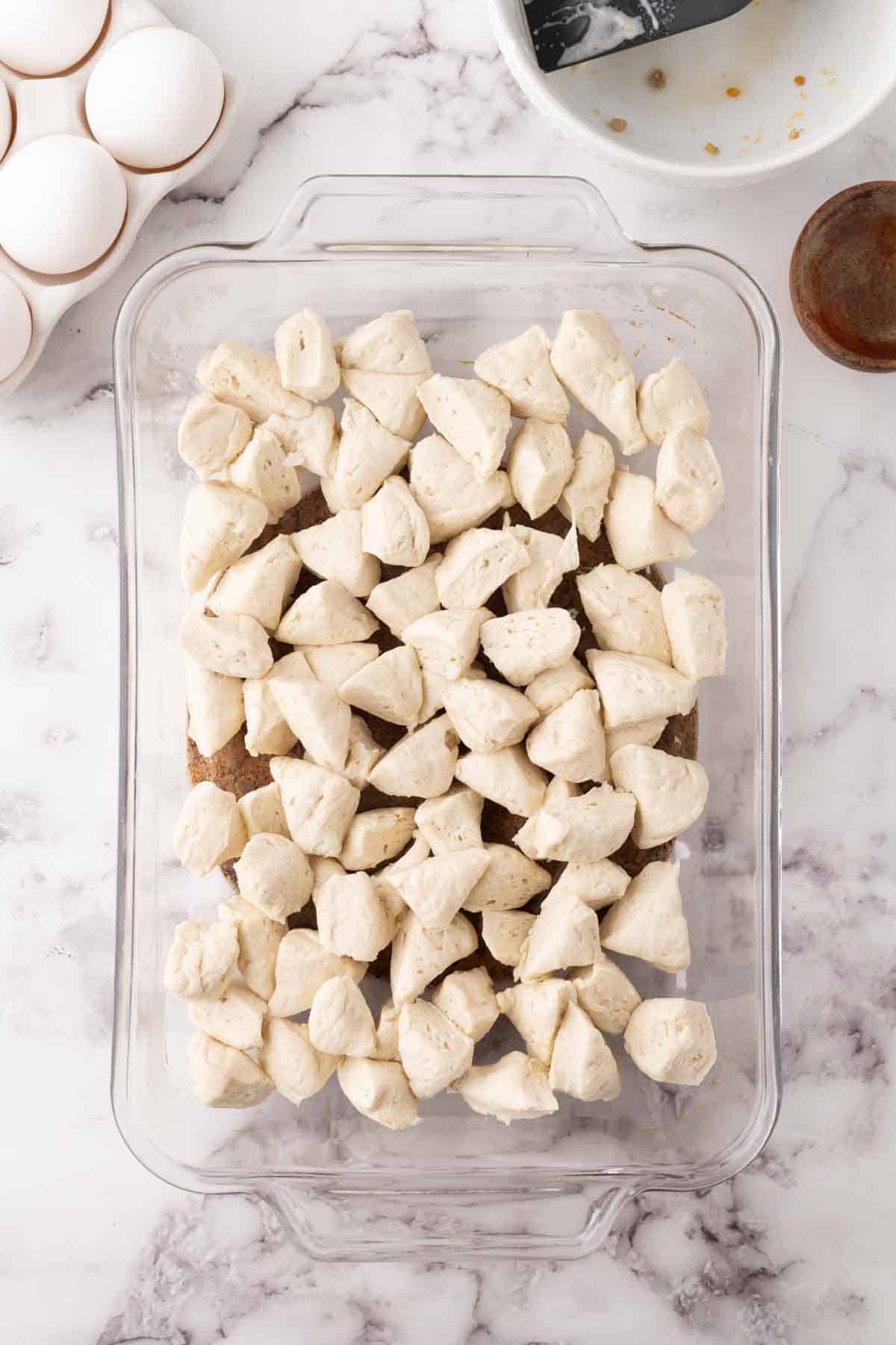 biscuit dough chopped up into a casserole dish for the biscuits and gravy casserole recipe.