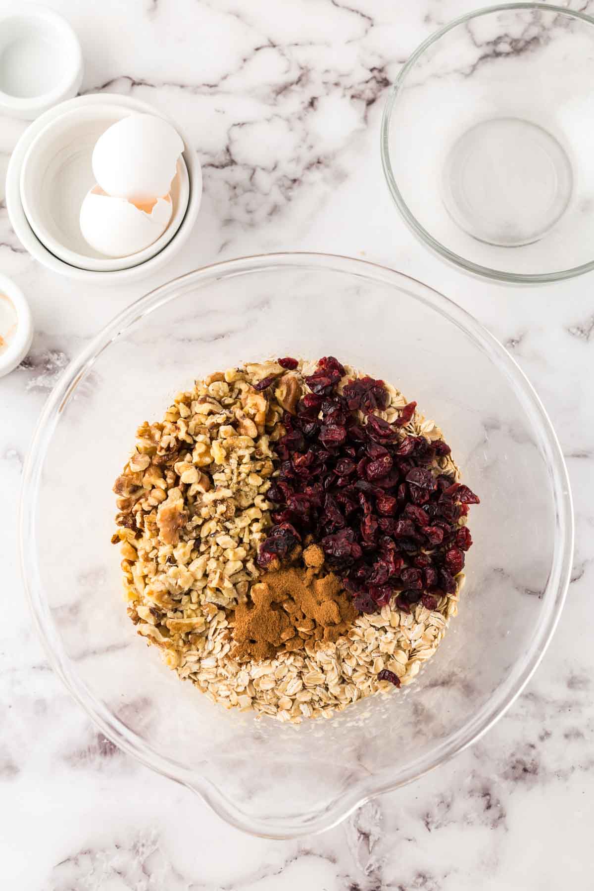 clear mixing bowl with breakfast bar ingredients in progress.