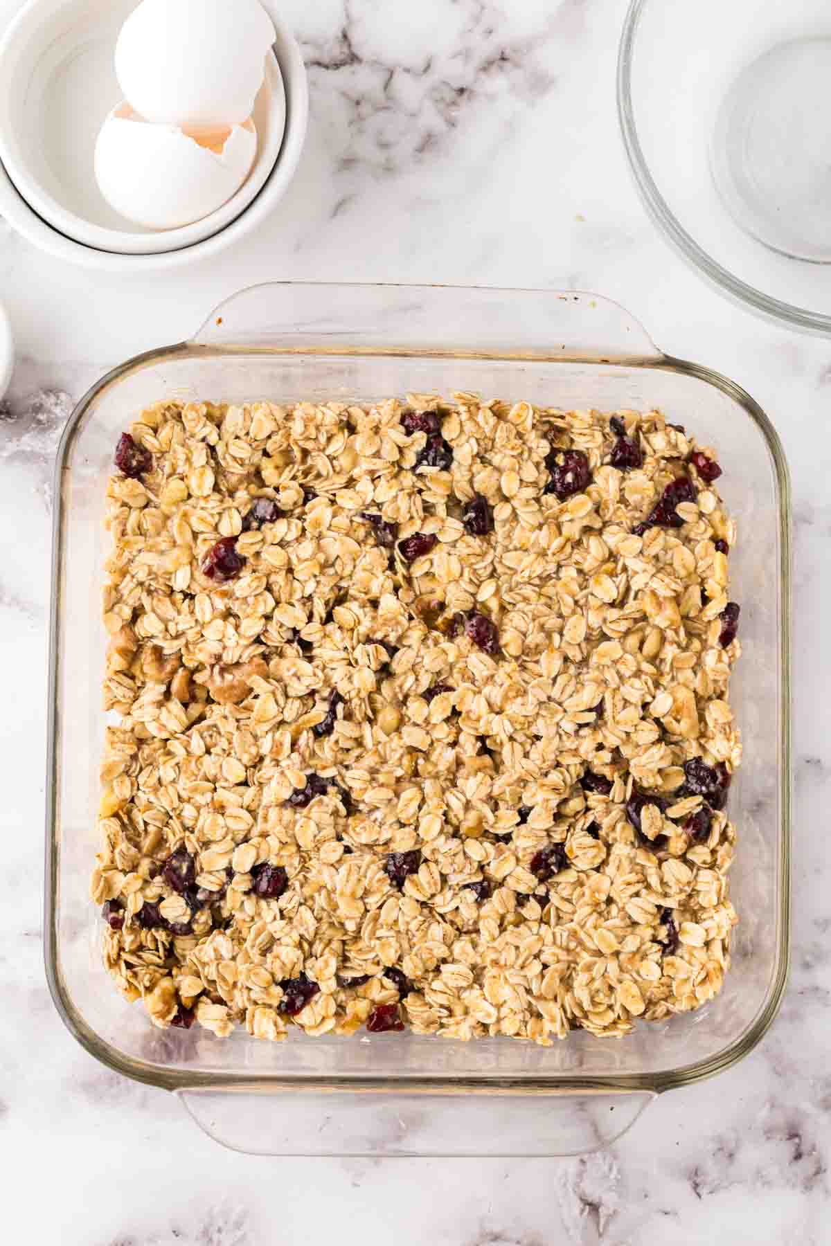 square baking dish with breakfast bar ingredients in progress.