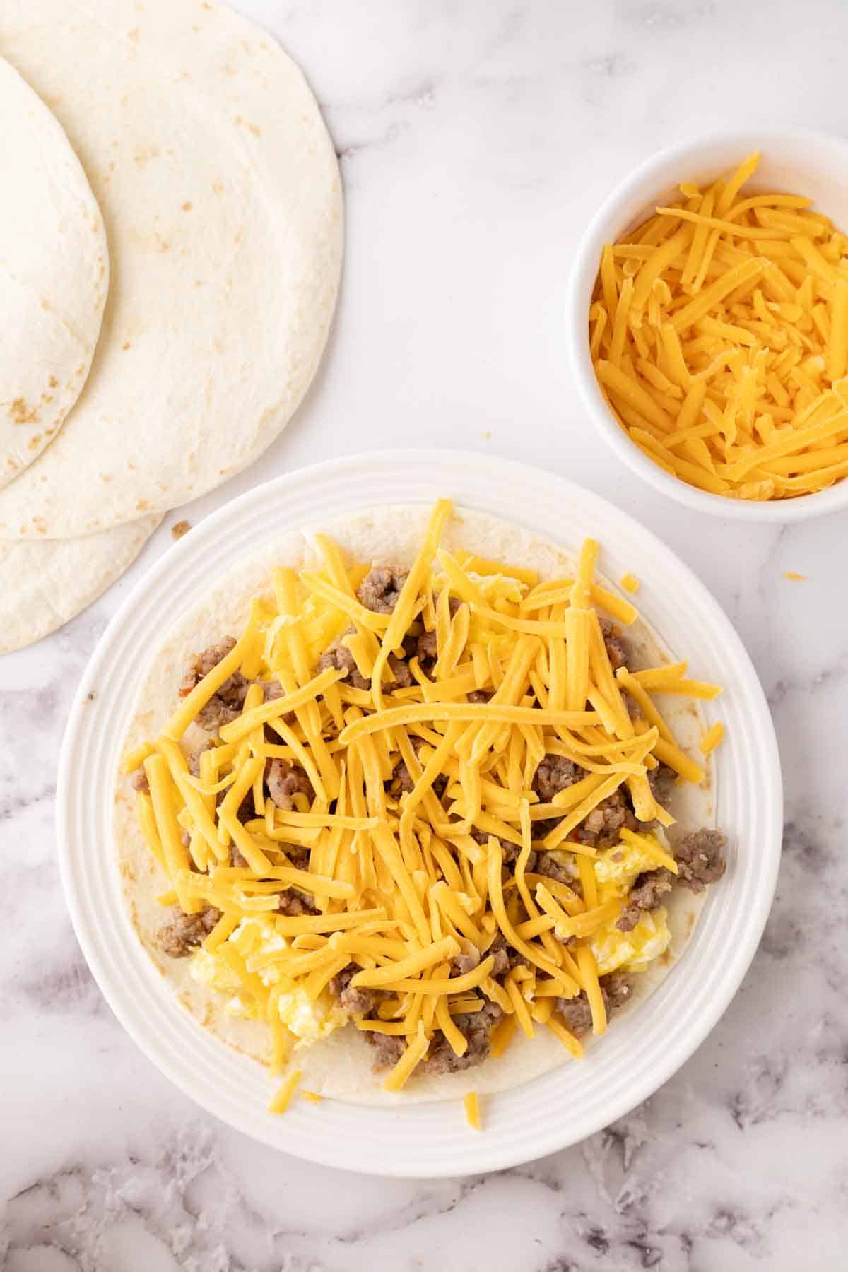 flour tortilla with breakfast quesadilla recipe in progress.