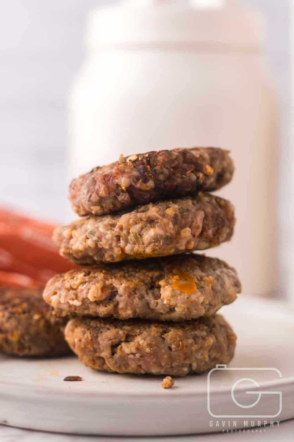 round plate with a tall stack of homemade breakfast sausage.