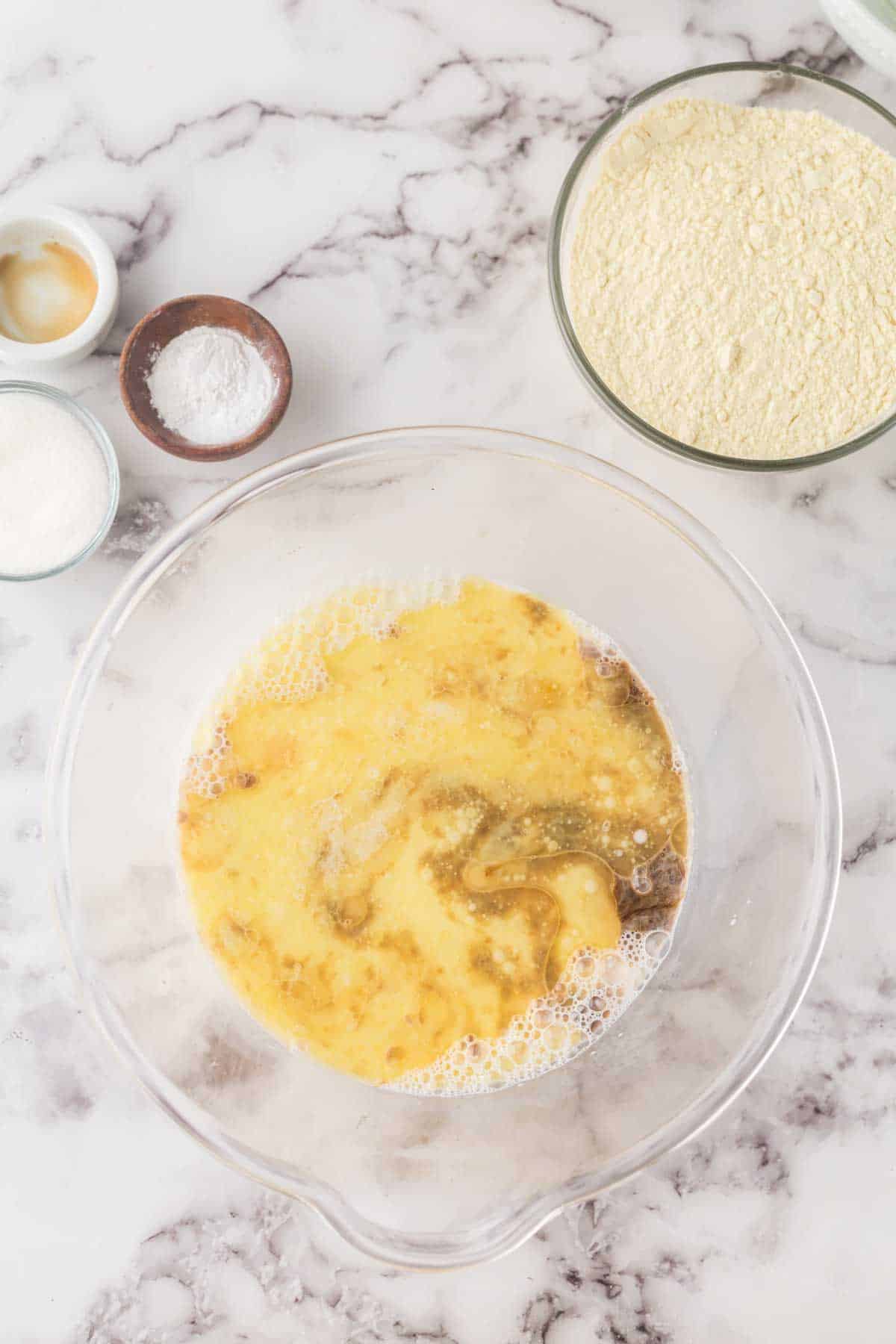 clear mixing bowl with buttermilk pancake batter in progress.