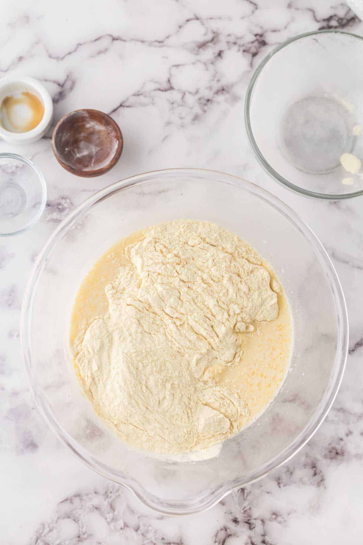 clear mixing bowl with buttermilk pancake batter in progress.