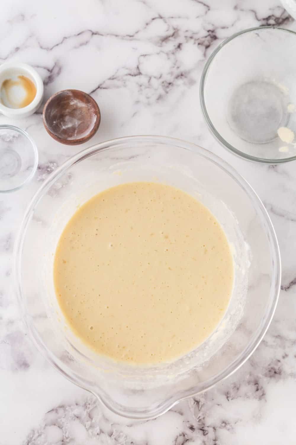 clear mixing bowl with buttermilk pancake batter in progress.