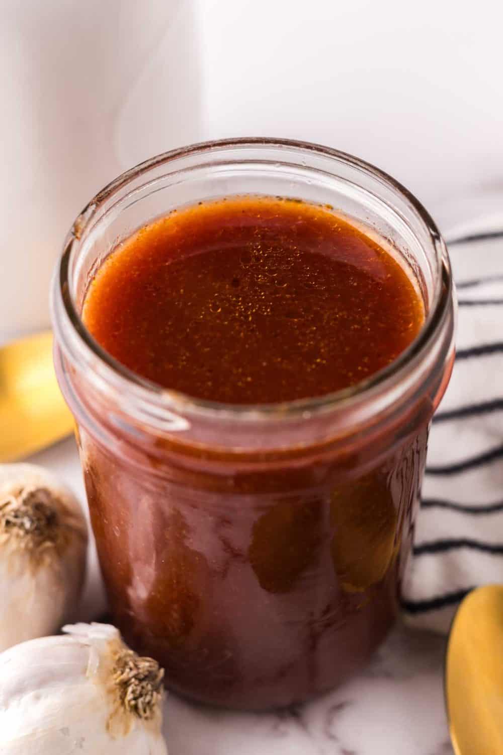 small glass mason jar with Catalina dressing recipe.