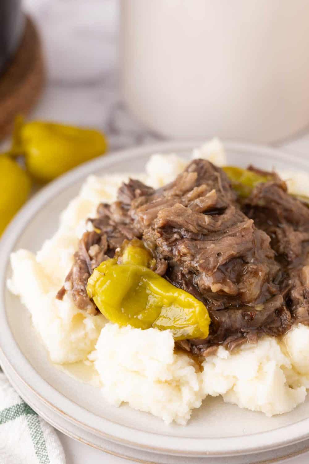 tender Mississippi shredded pot roast with pickled banana peppers over rice.