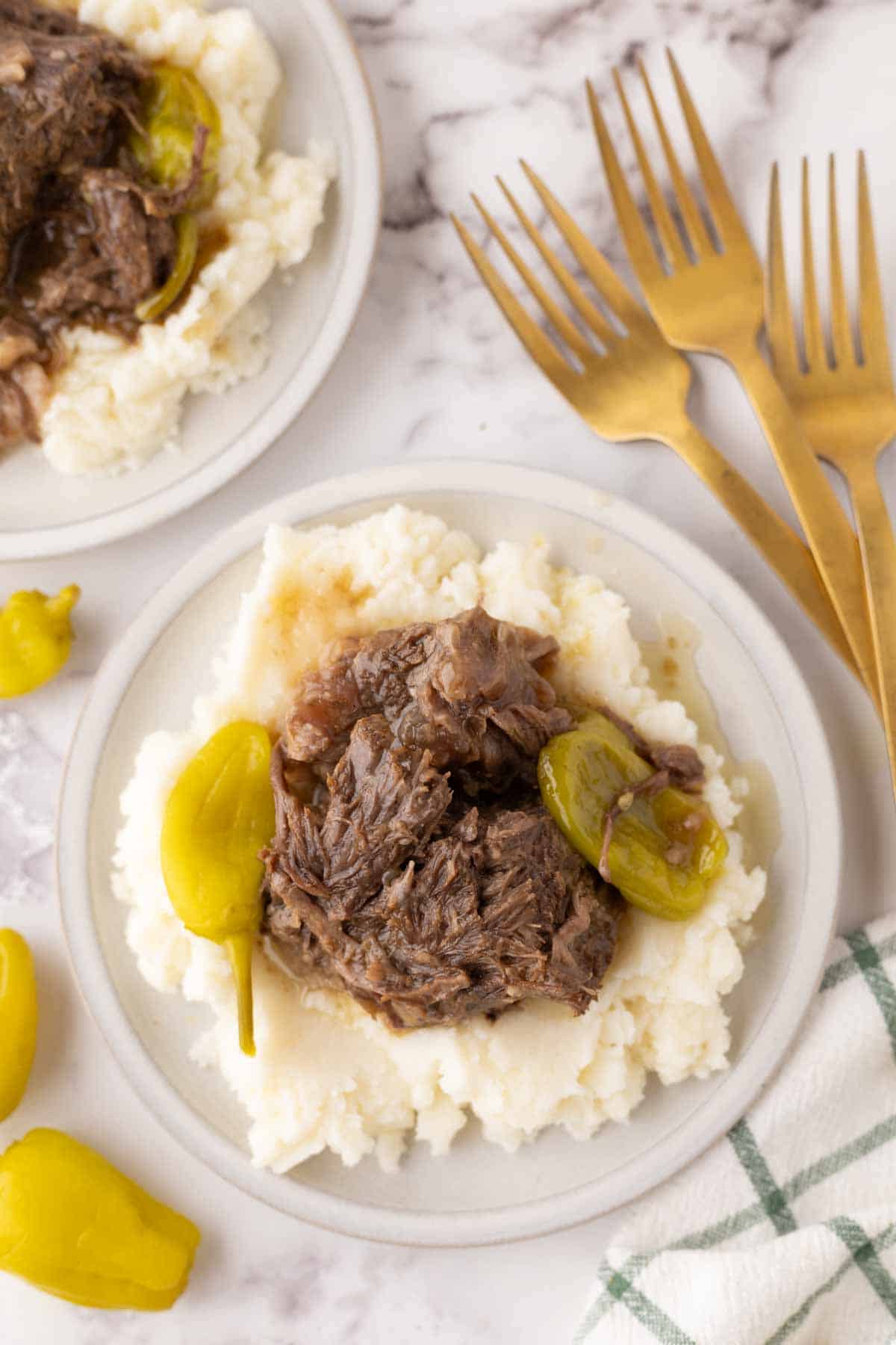 tender Mississippi shredded pot roast with pickled banana peppers over rice.