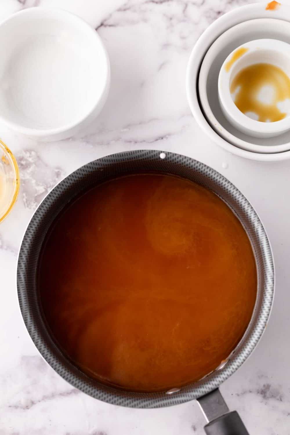 Combining ingredients in a pan for sweet and sour sauce.