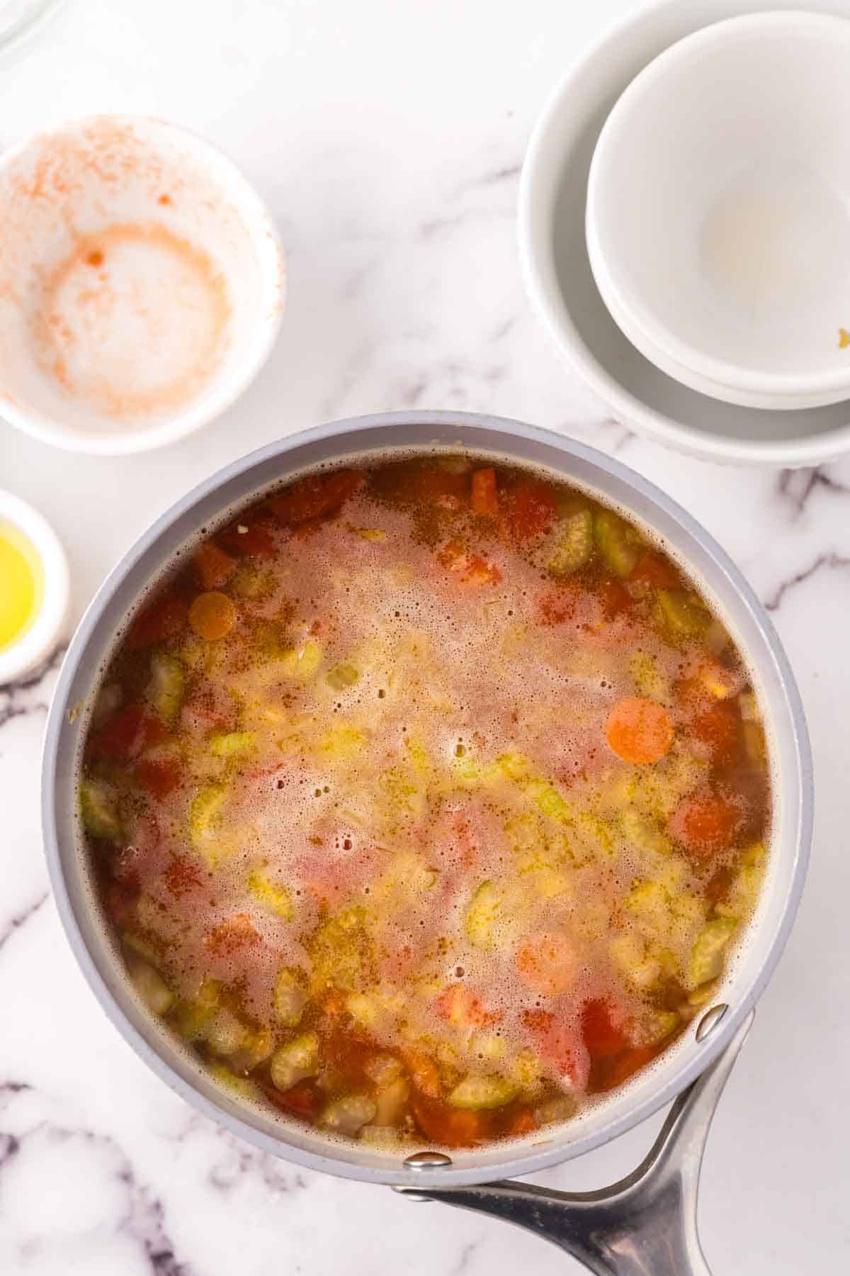 Pot of simmering vegetable soup.