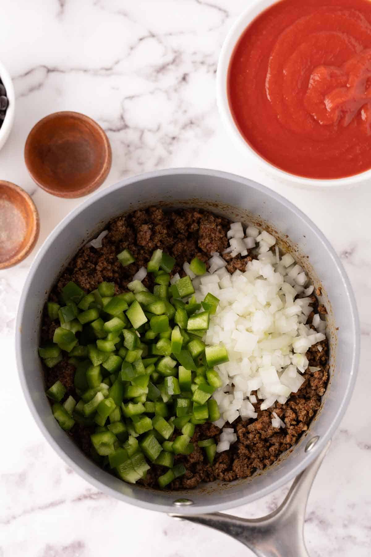 Added veggies to the ground beef and spices.