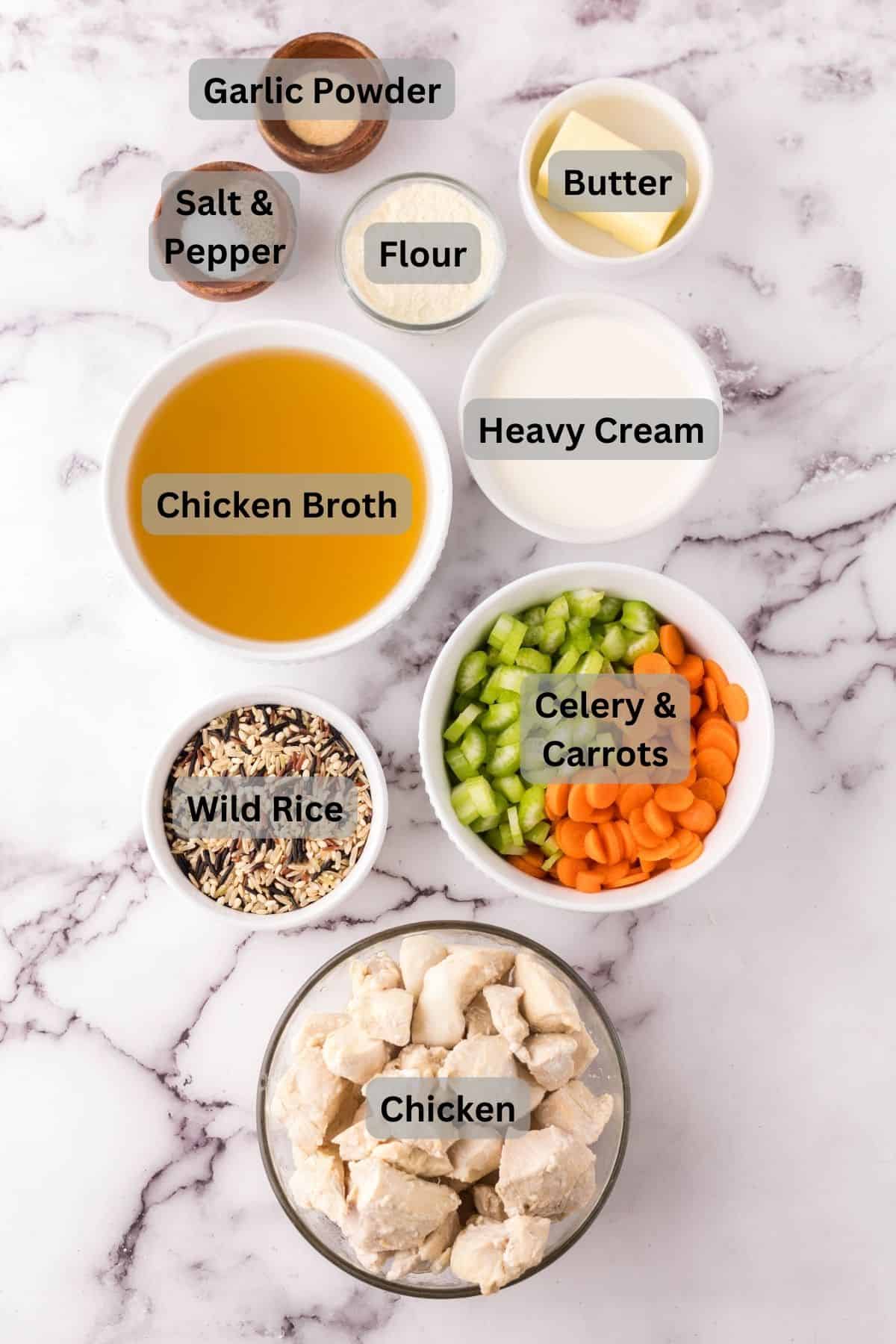 portion bowls each with digitally labeled raw ingredients to make chicken wild rice soup recipe.