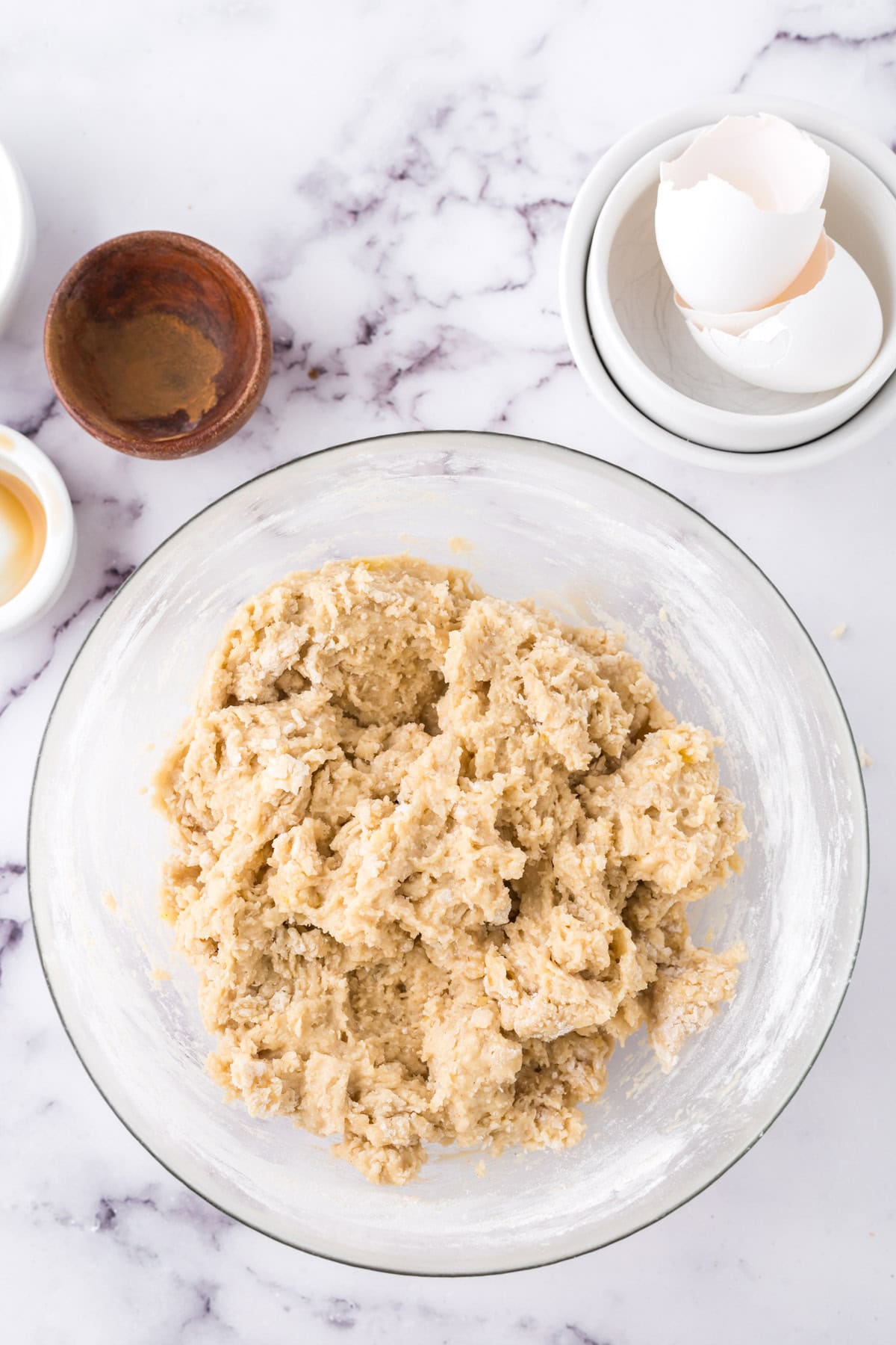 The dough for donuts in a glass bowl.