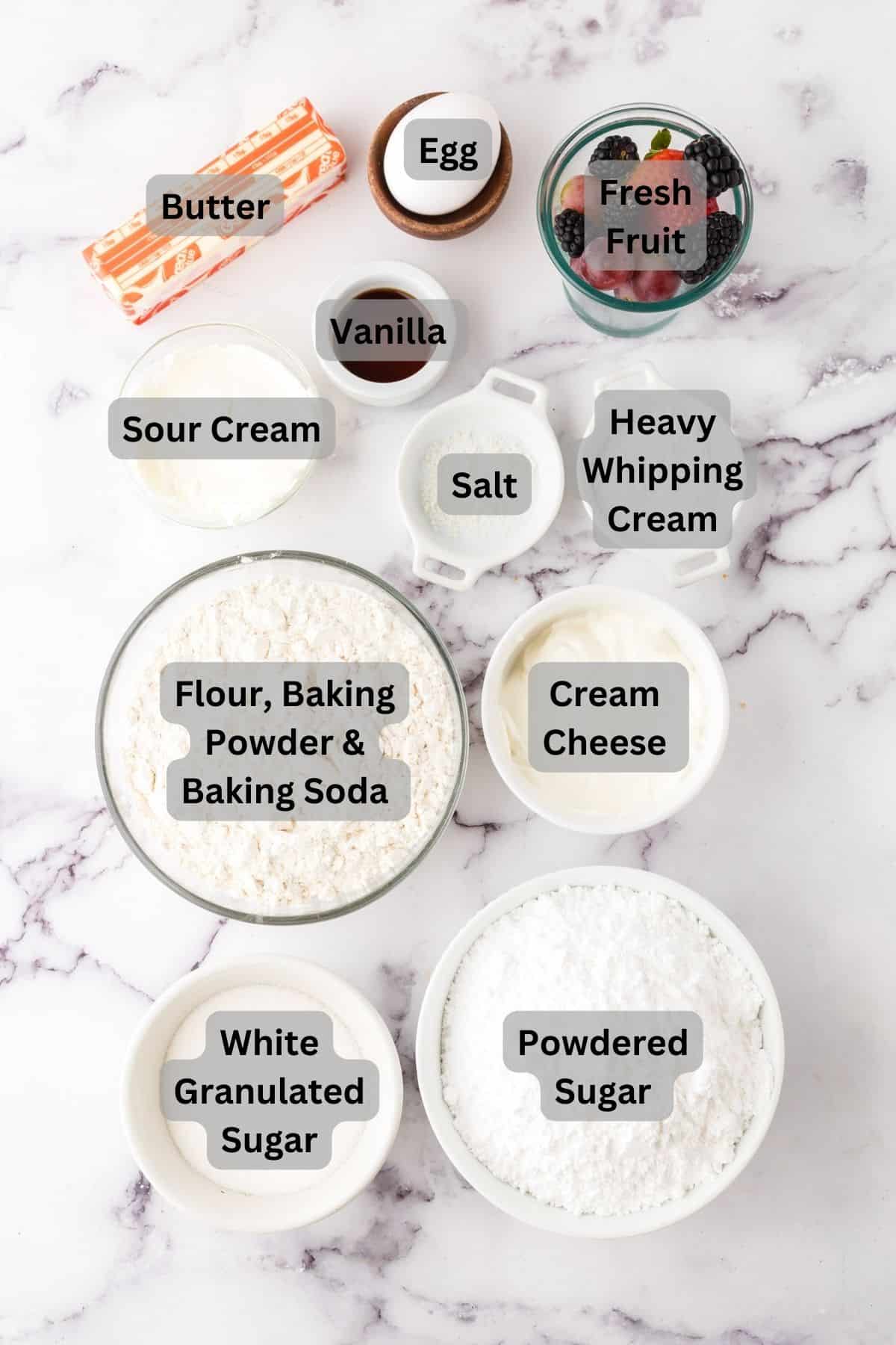 portion bowls each with digitally labeled raw ingredients to make Fruit pizza cookies.