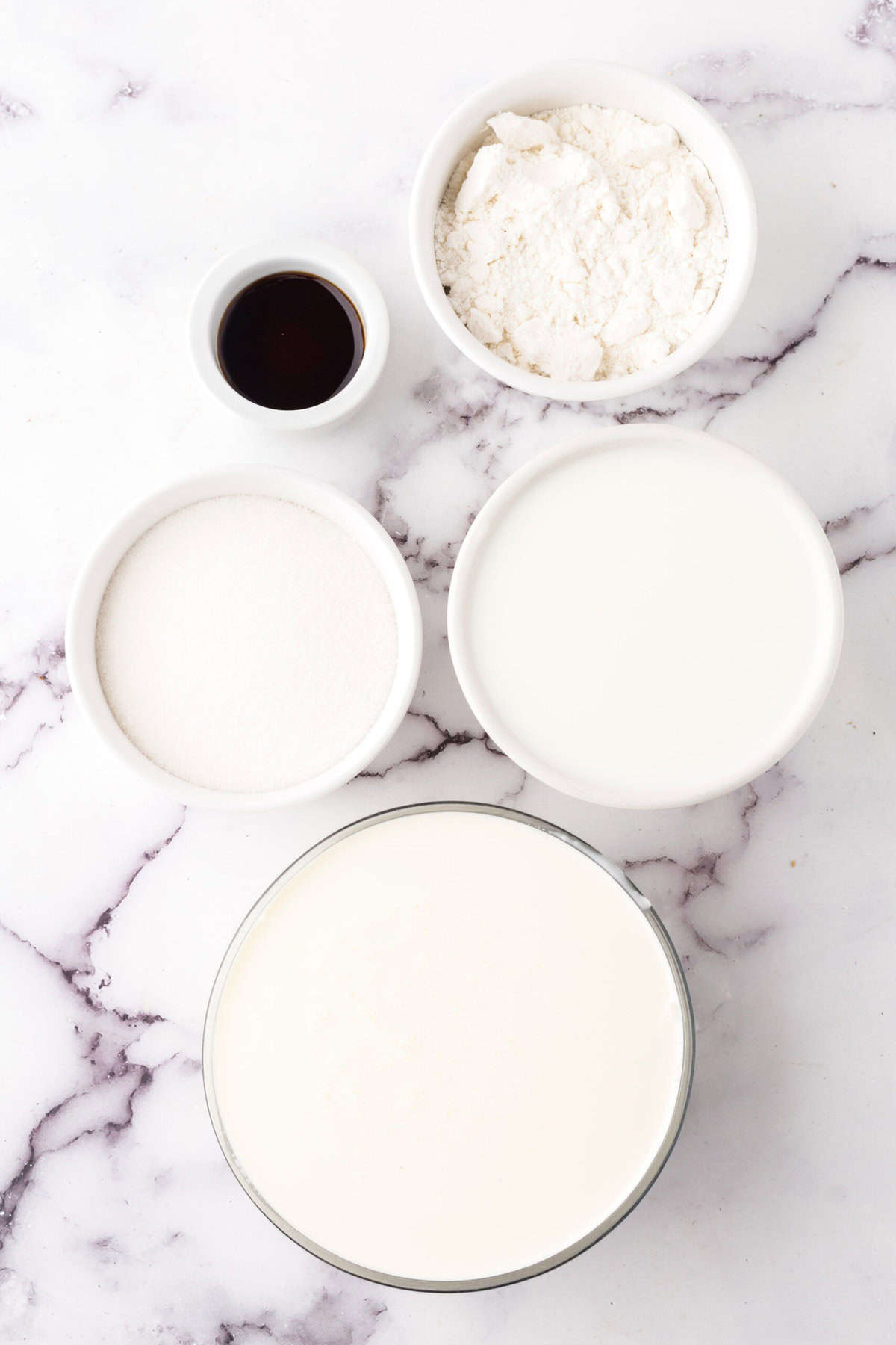 portion bowls each with raw ingredients to make cake batter ice cream recipe.