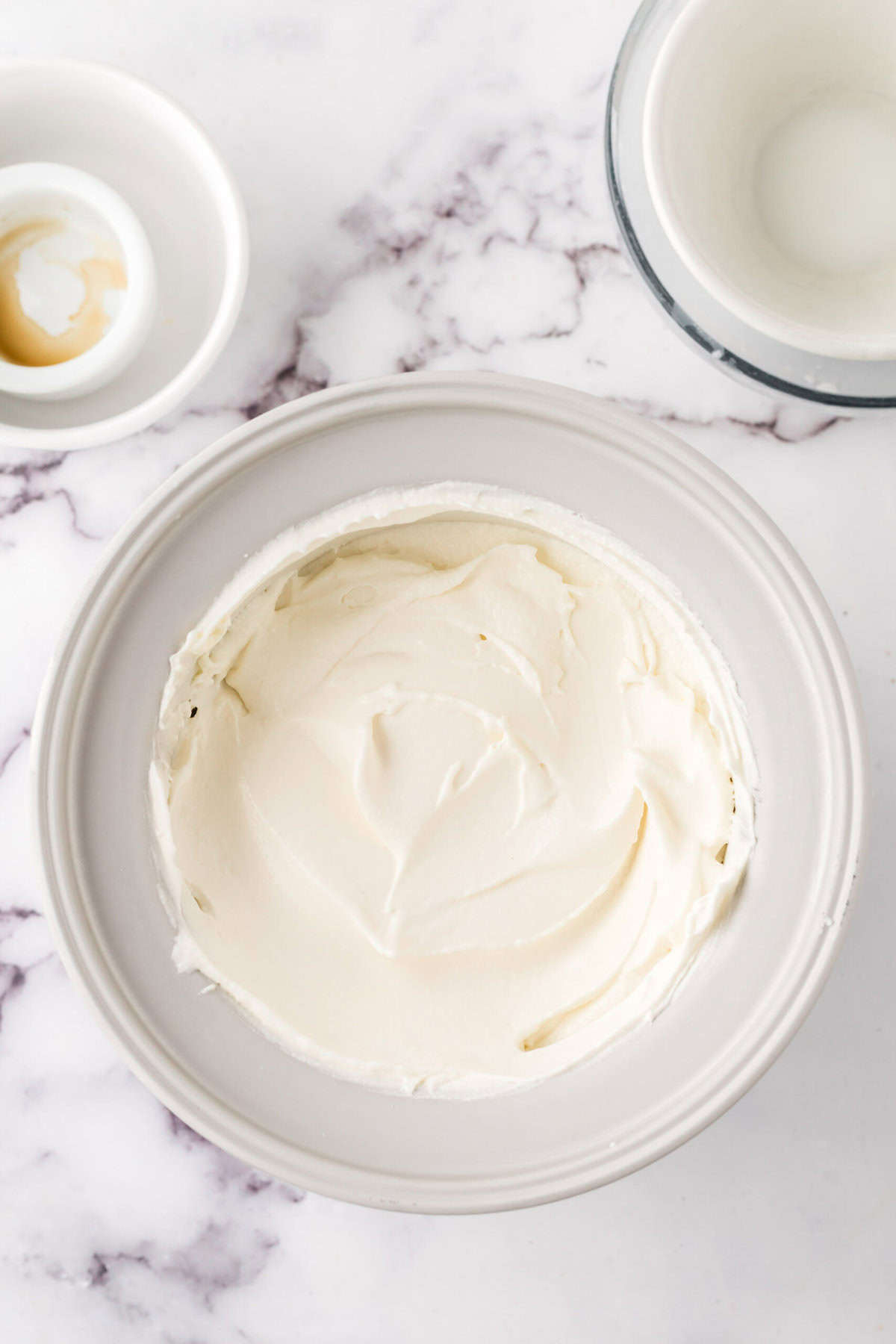 clear mixing bowl in the process of making cake batter ice cream.