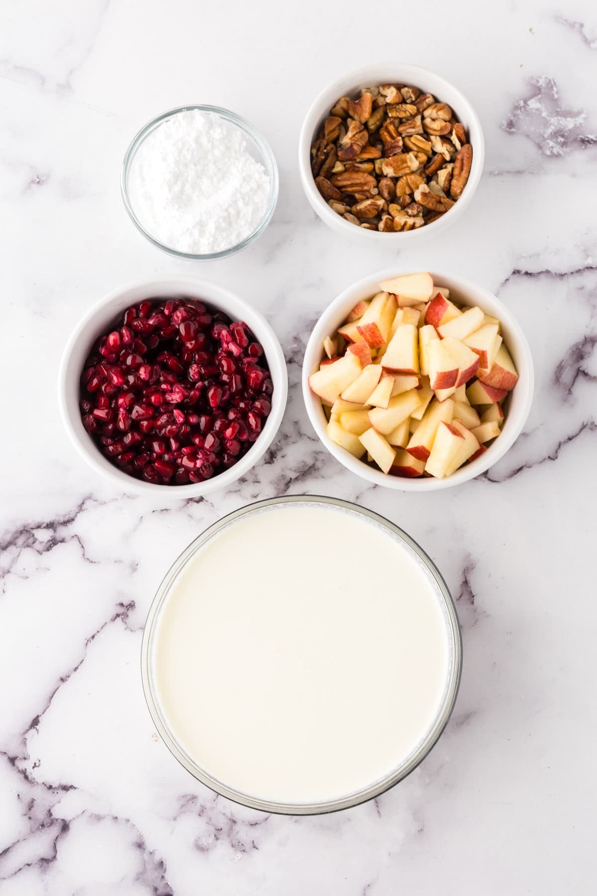 portion bowls each with raw ingredients to make the dixie salad recipe.