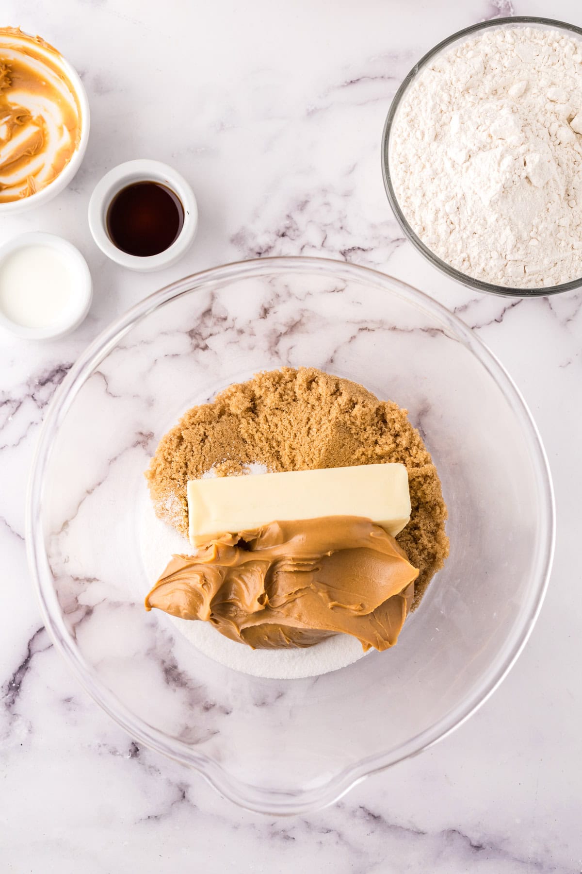 clear mixing bowl in the process of making peanut butter cookies.