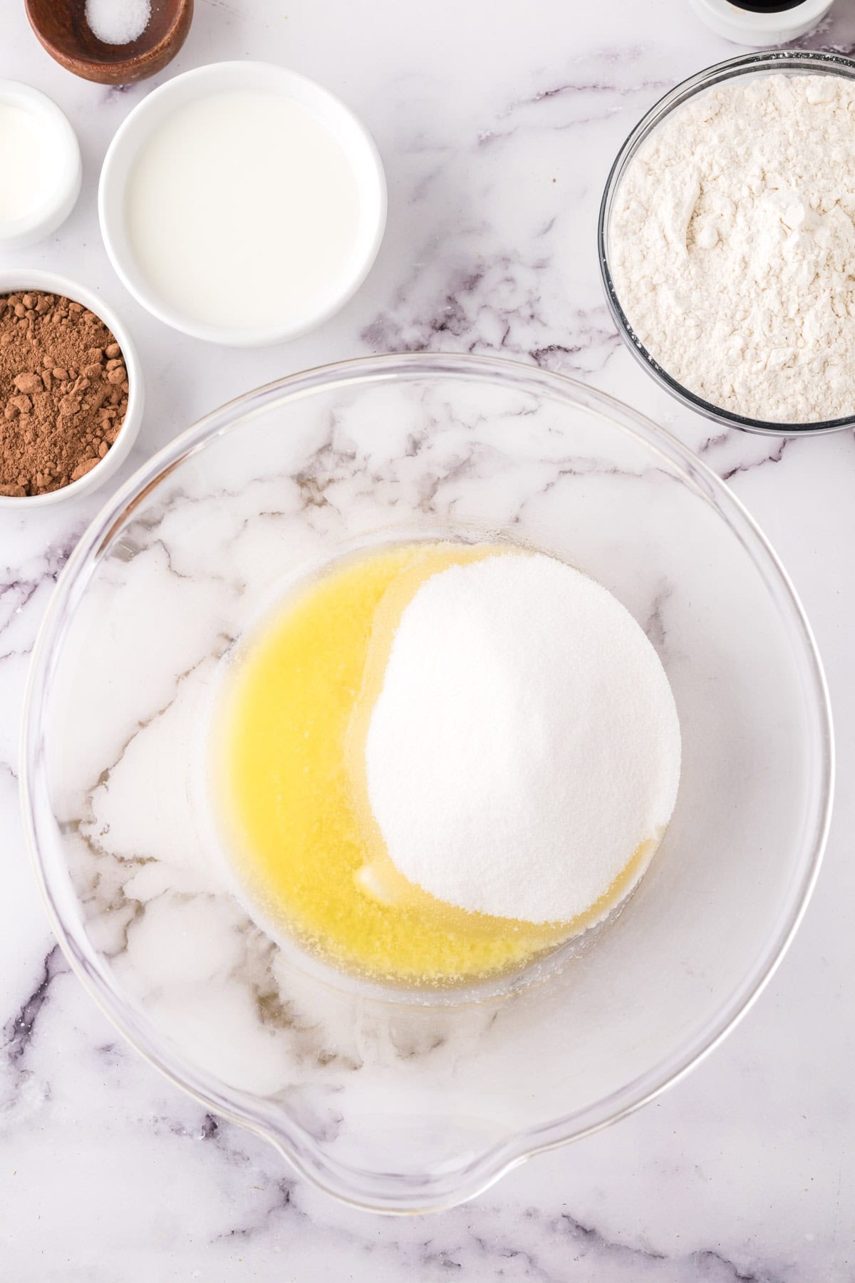 clear mixing bowl in the process of making vanilla cupcake batter.
