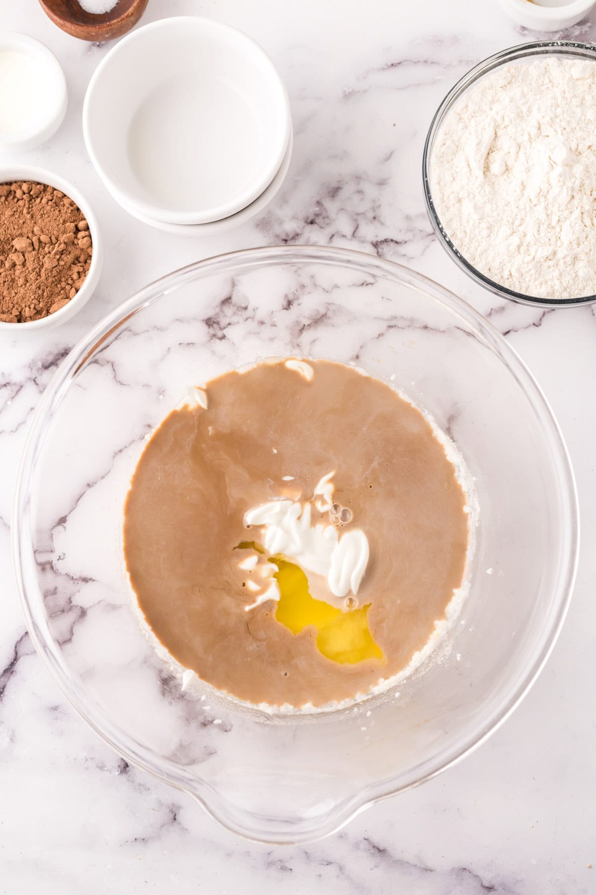 clear mixing bowl in the process of making vanilla cupcakes with chocolate frosting recipe.