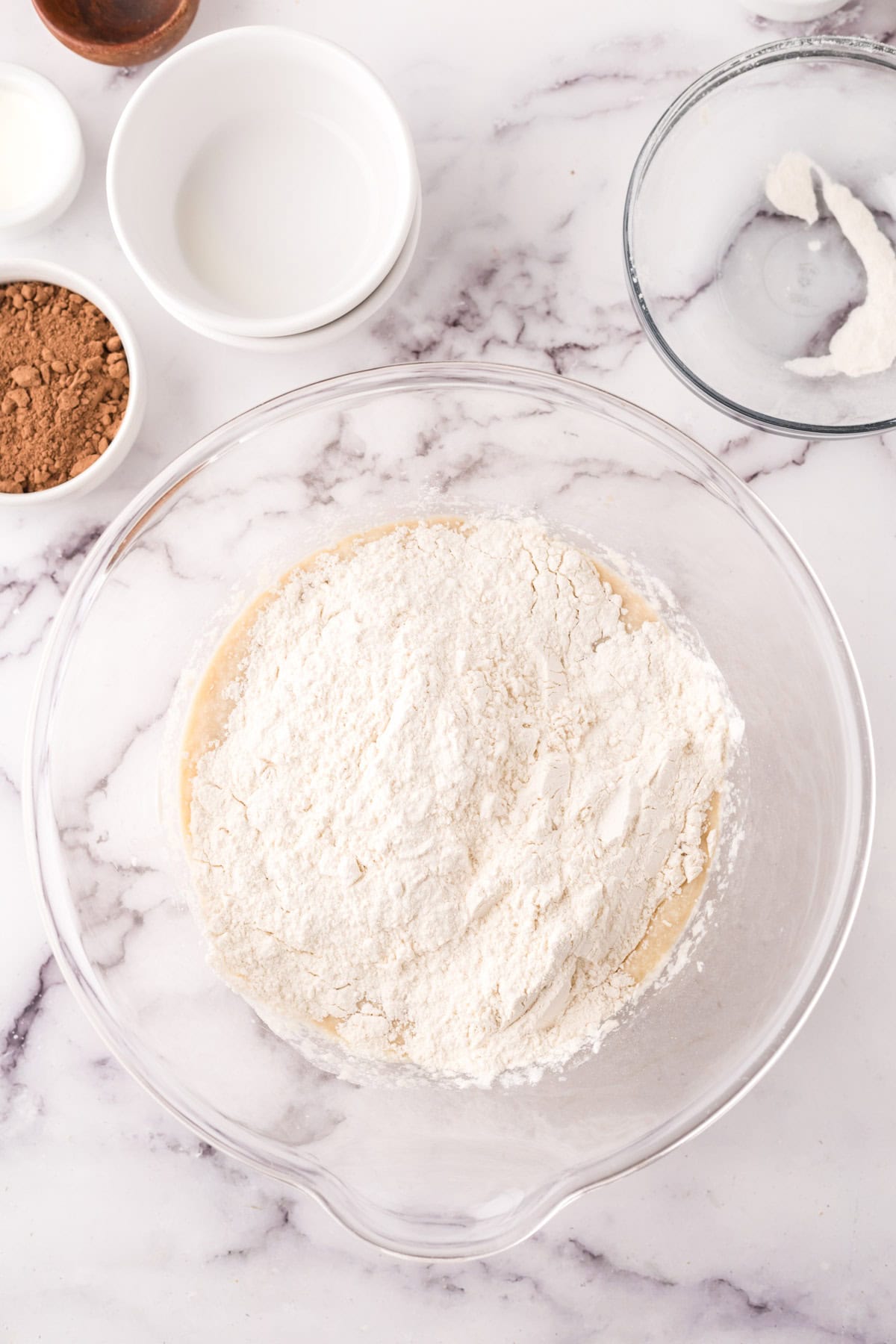 clear mixing bowl in the process of making vanilla cupcakes with chocolate frosting recipe.