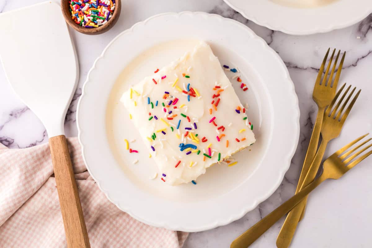 round white plate with one square portion of vanilla sheet cake.