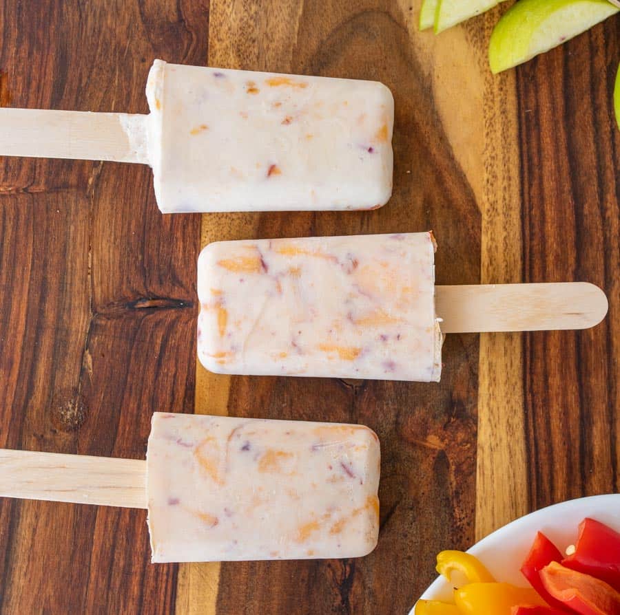 Close up of the homemade popsicles on a wooden board.