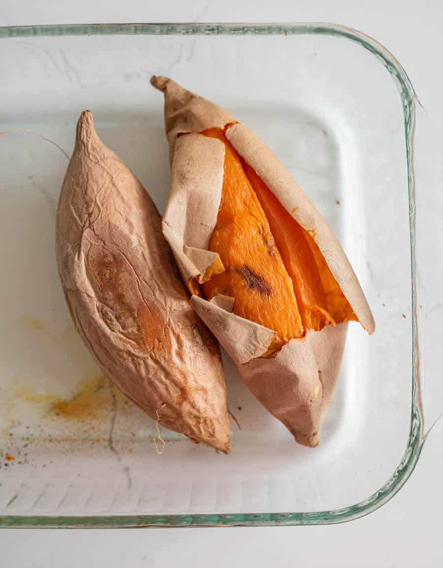 Baked sweet potatoes in a clear glass pan.