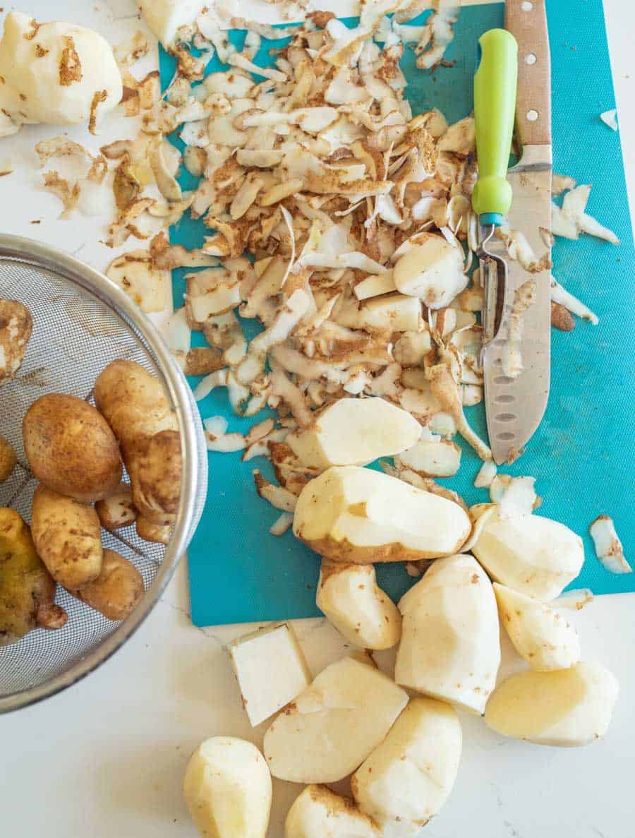 Peeling raw potatoes.
