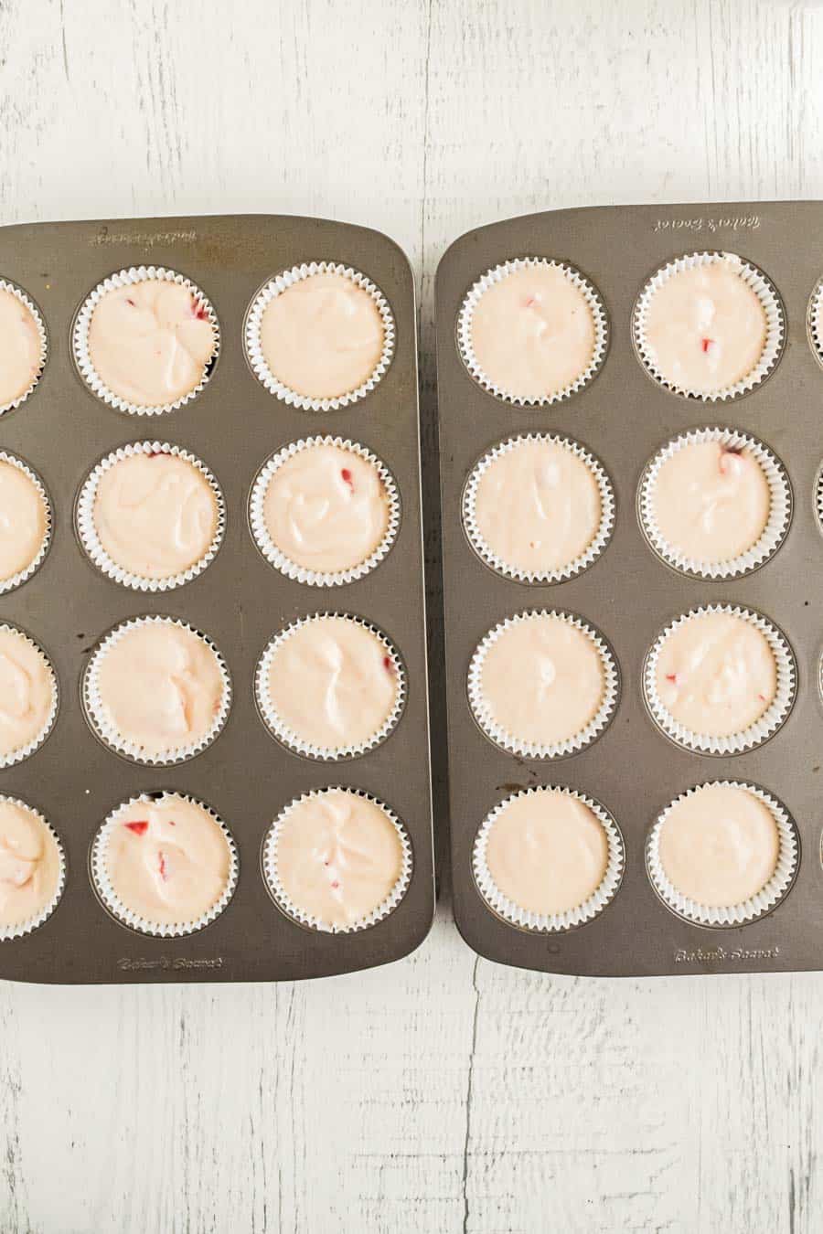 Raw homemade cherry chip cupcake batter in the tins ready to bake.