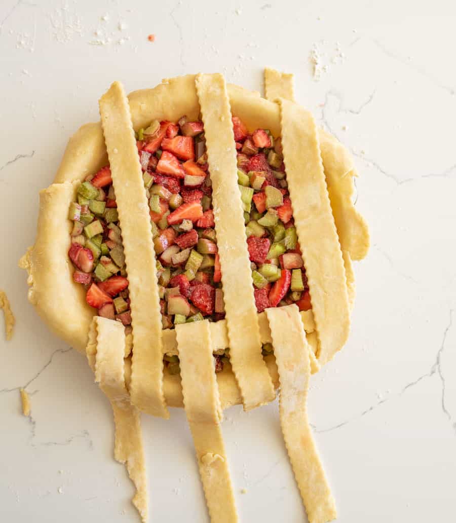 Three strips of pie crust folded back.