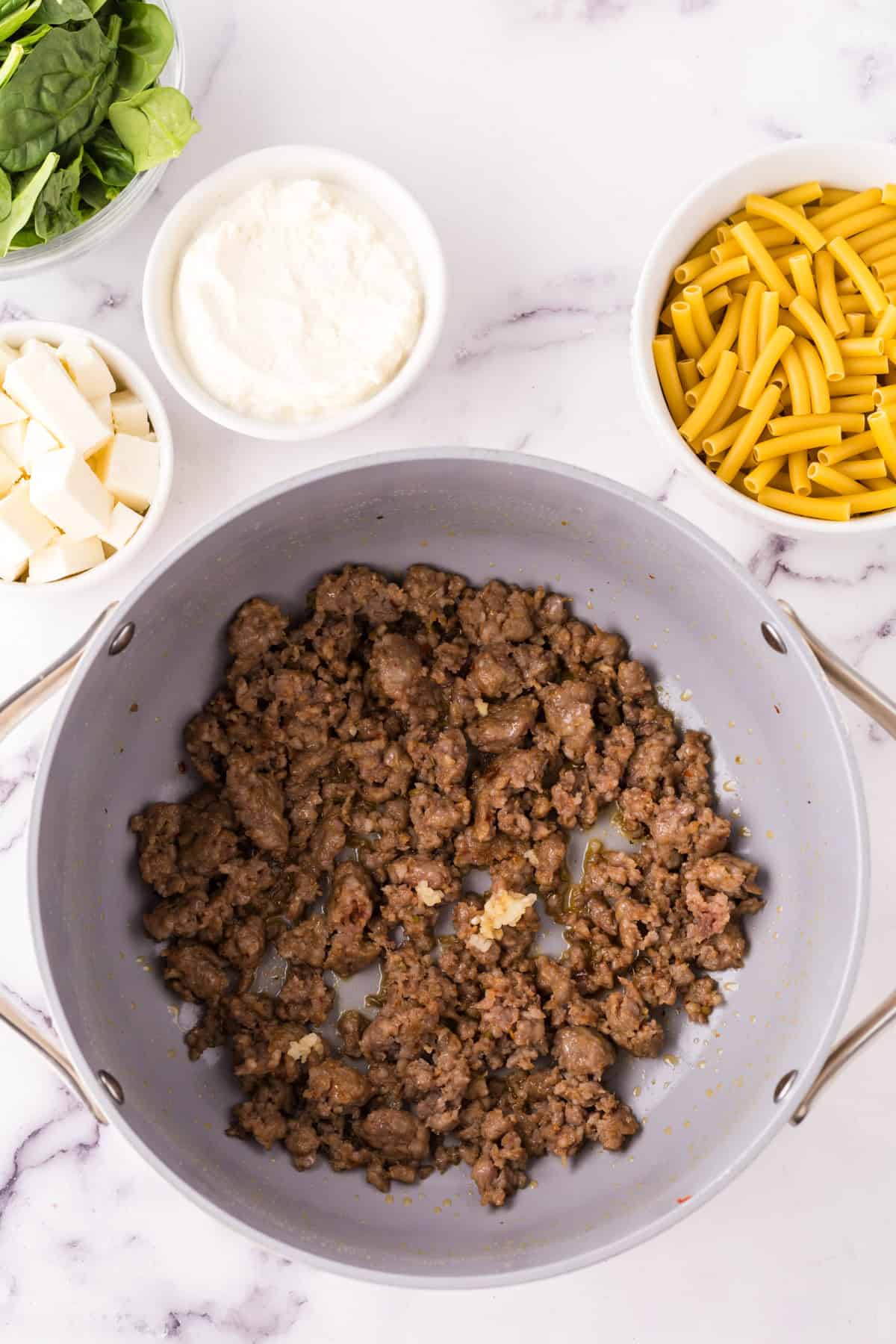 pan cooking off meat in the process of making one pot baked ziti recipe.