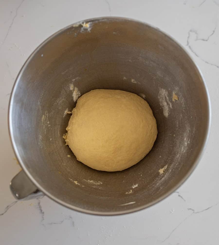 Ball of sourdough for hamburger buns in a bowl ready for the resting period.