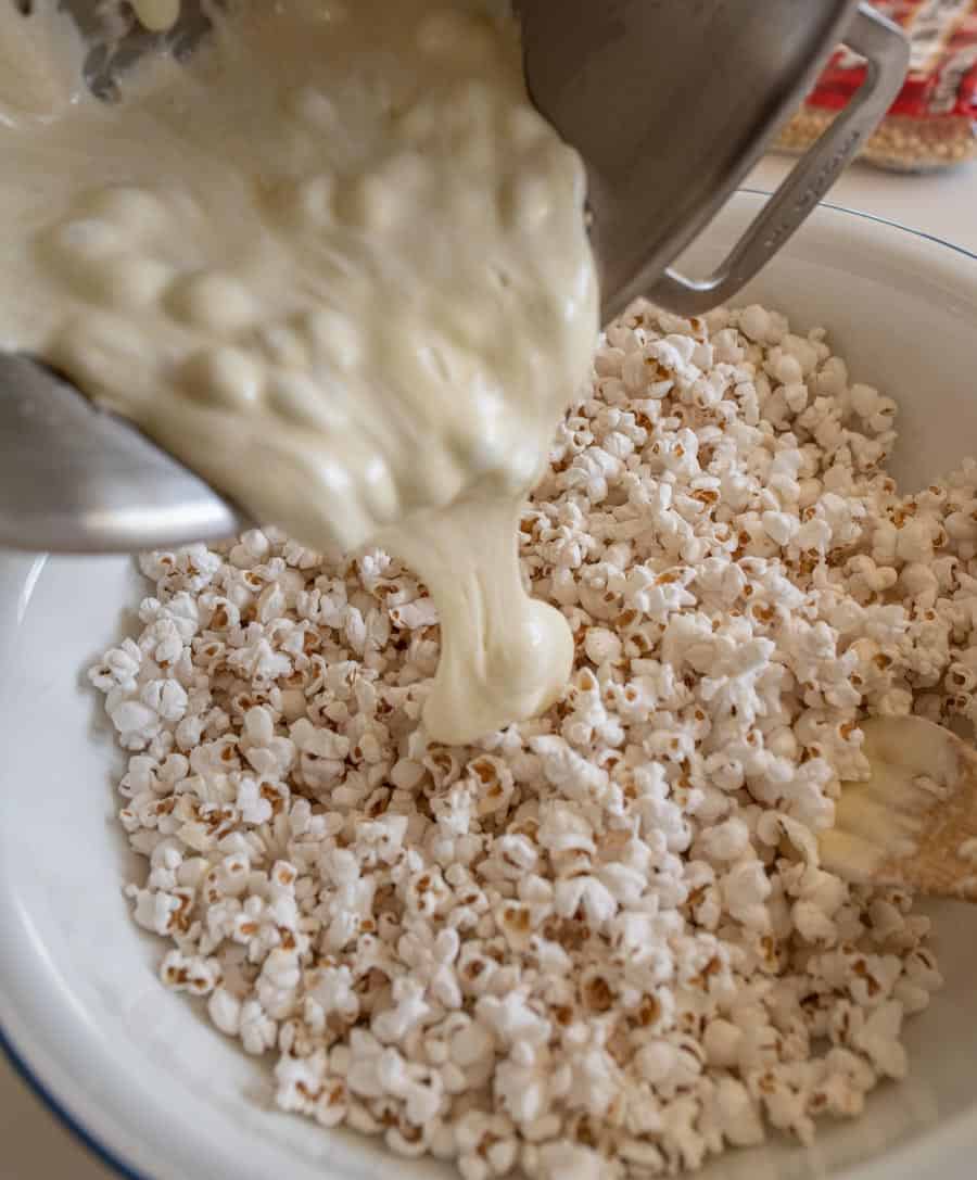 Marshmallow mixture being poured over the popped popcorn.