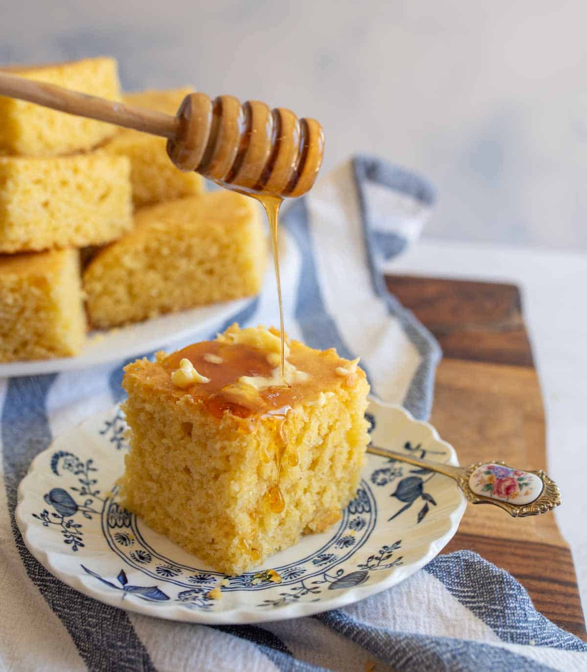 cornbread with butter and honey on a plate