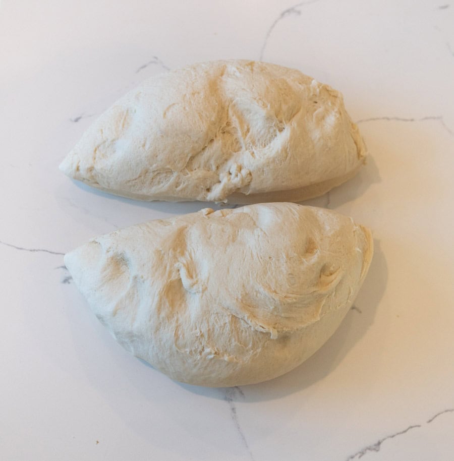 Ball of dough divided into two pieces before being formed into loaves.