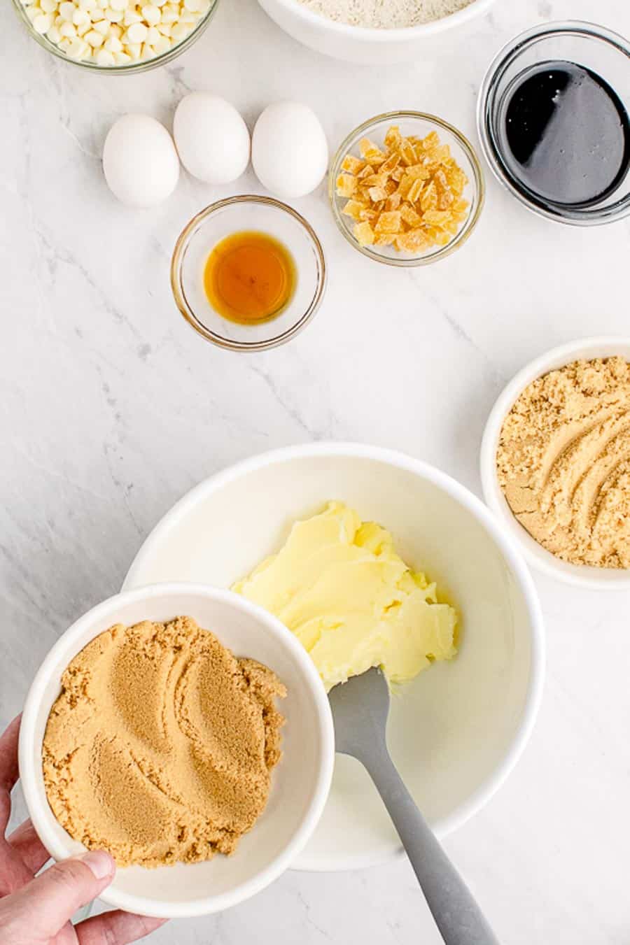 White mixing bowl in the process of making gingerbread blondie batter.