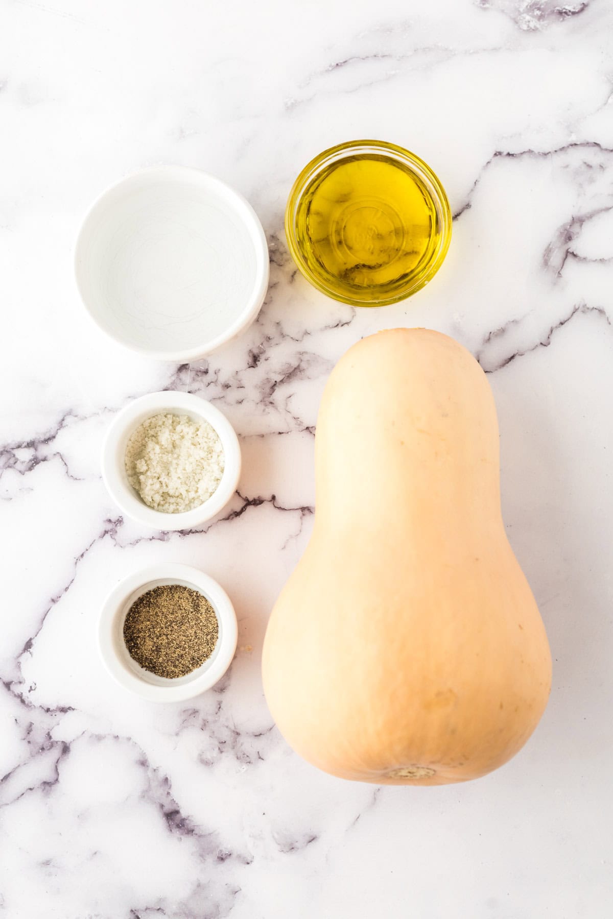 portion bowls each with raw ingredients to make roasted butternut squash.