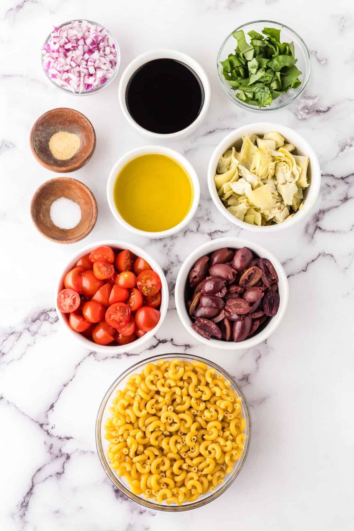 portion bowls each with raw ingredients to make Italian Pasta Salad Recipe.